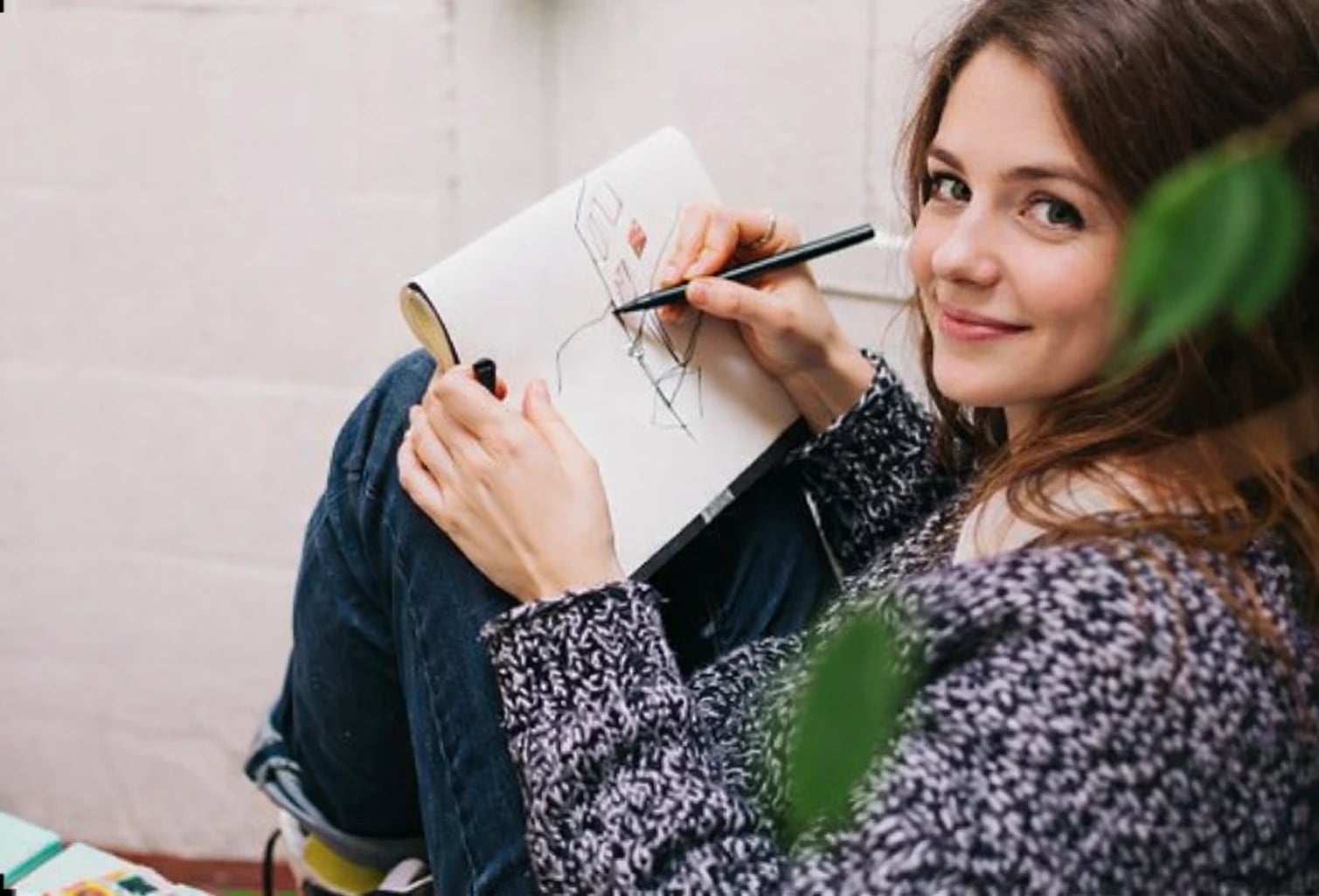 young woman making sketch