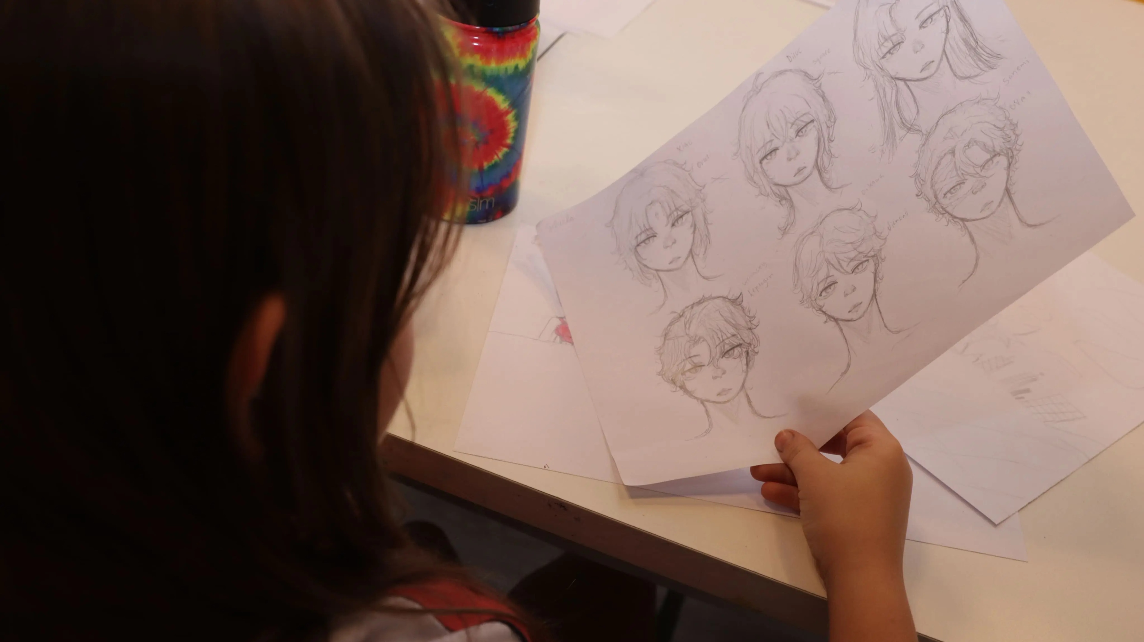 Adolescente desenhando mangá em sala de aula